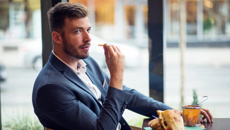 Confident businessman have a lunch in restaurant