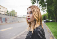 Portrait young blonde woman posing outdoor confident