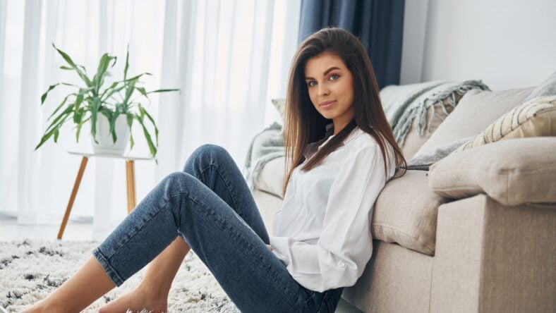 Beautiful young woman in jeans and white