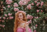 Happy smiling redhead freckled woman plays with