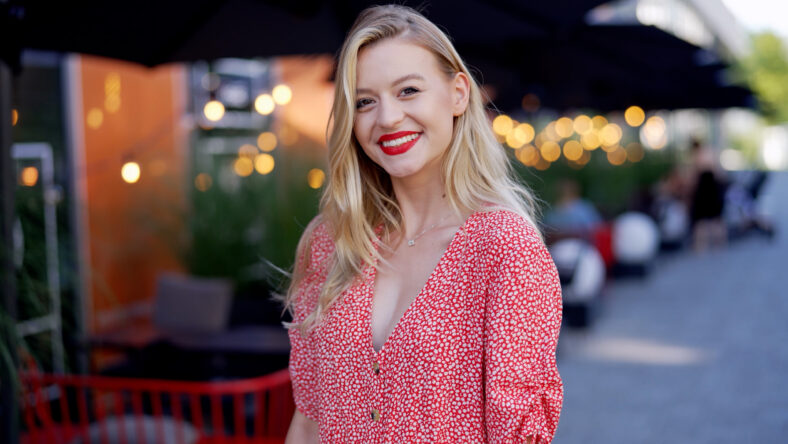 Happy young female in trendy dotted garment