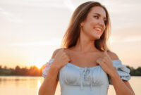 Cheerful smiling woman posing on beach in