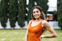 pretty brunette woman in an orange dress