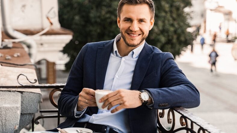 Handsome man with cup of coffee in