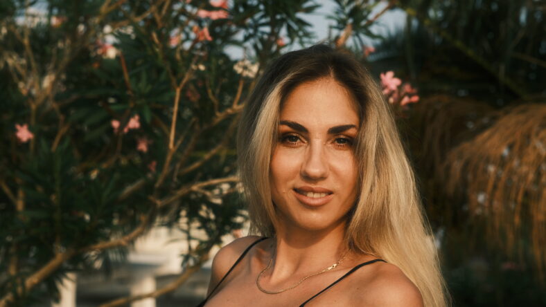 Beautiful model posing in sunset sunlight in the park