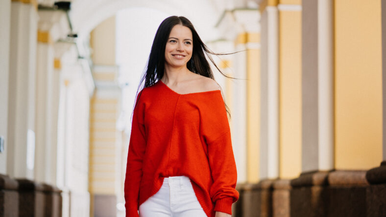 Satisfied young attractive brunette woman smiling looking