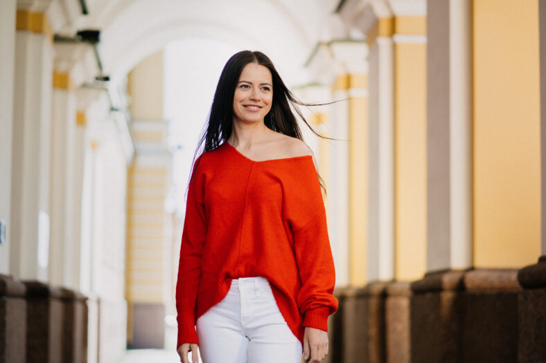 Satisfied young attractive brunette woman smiling looking