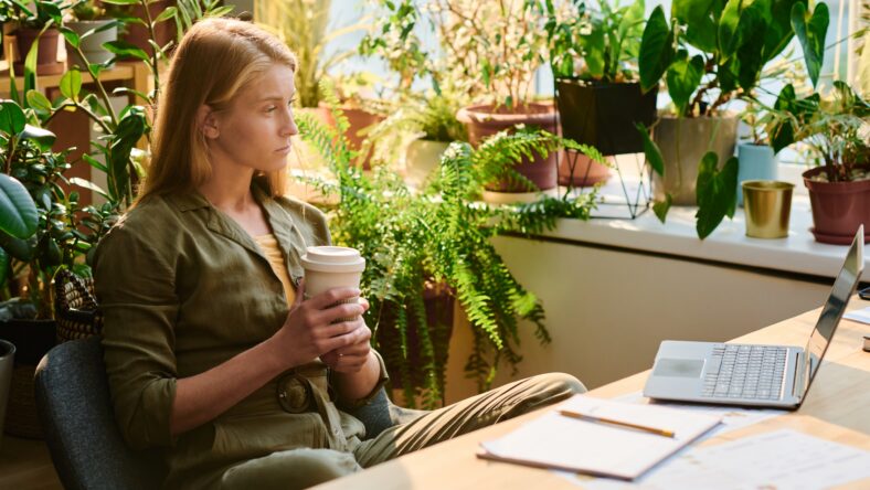 Young blond woman with cup of coffee
