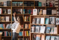 Teen girl among a pile of books.