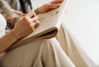 Close up of young woman's hands drawing