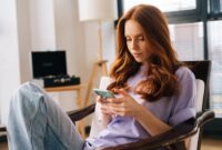 Portrait of thoughtful focused young woman texting