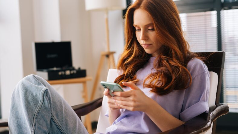 Portrait of thoughtful focused young woman texting