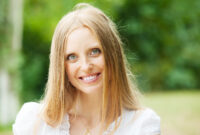 Smiling ordinary middle-aged woman against nature background