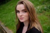 Blonde young woman on the street, white