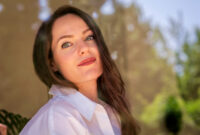 Headshot of beautiful young woman standing behind
