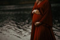 Woman in a beautiful red maternity evening