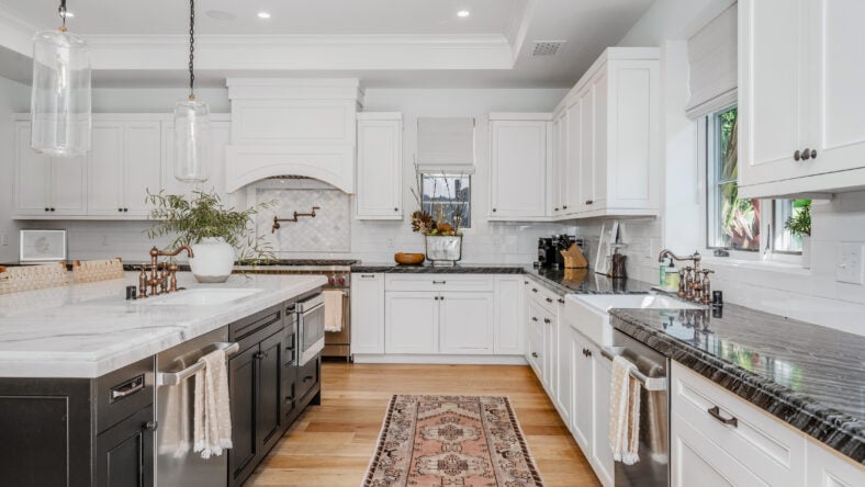 this white kitchen has wood floors and an oriental runner rug