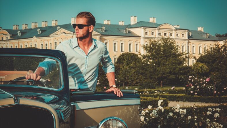 Confident wealthy young man with briefcase near
