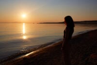 A pretty girl enjoys the sunset on